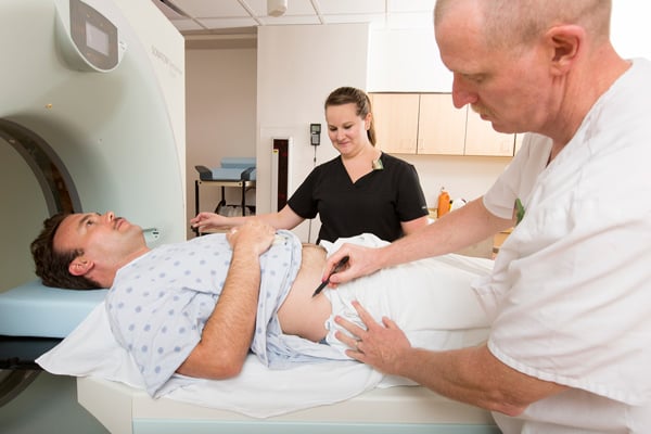 Radiologic Technologists working with a patient